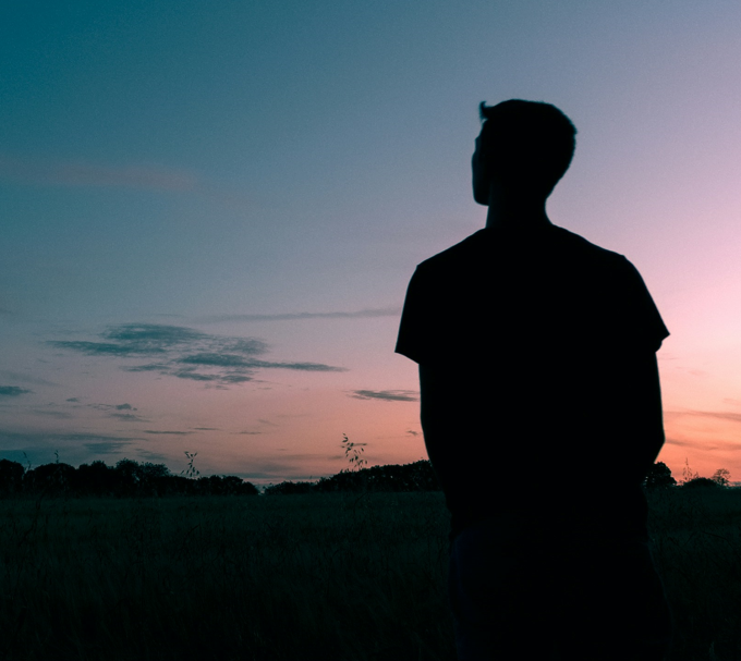 man staring at sky alone